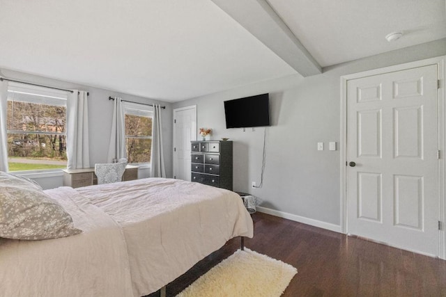 bedroom featuring baseboards, beamed ceiling, and dark wood finished floors