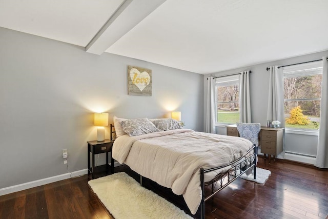 bedroom with baseboards, baseboard heating, hardwood / wood-style flooring, and beamed ceiling