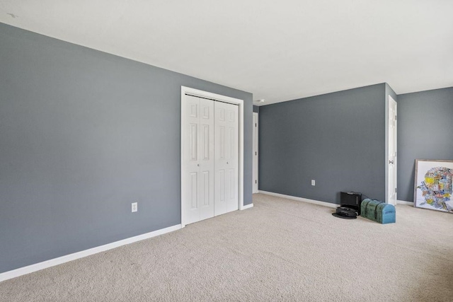 interior space with carpet floors and baseboards
