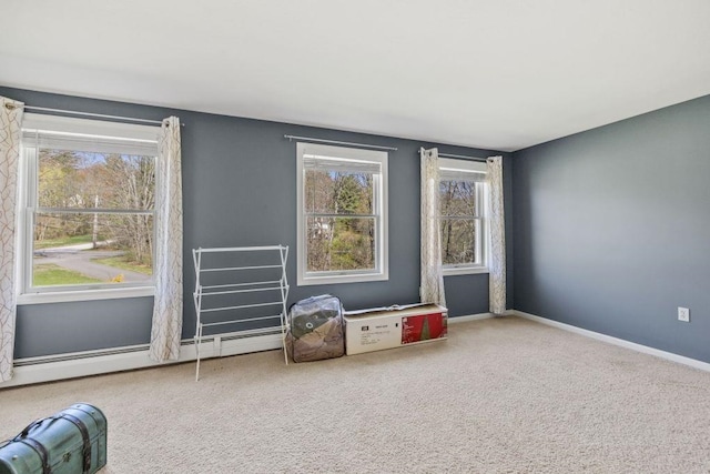 interior space featuring baseboards, carpet flooring, a wealth of natural light, and baseboard heating