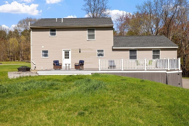 back of house with a lawn, a shingled roof, a patio area, and a deck