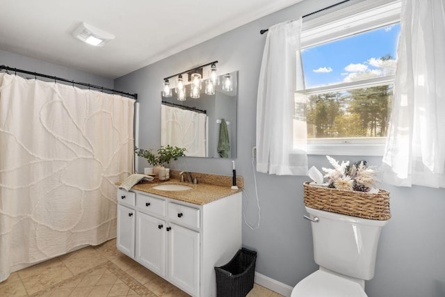 bathroom featuring vanity, tile patterned flooring, and toilet