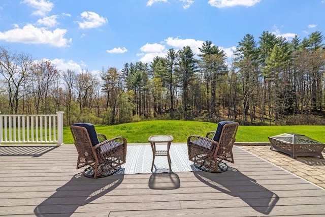 deck featuring a lawn and an outdoor fire pit