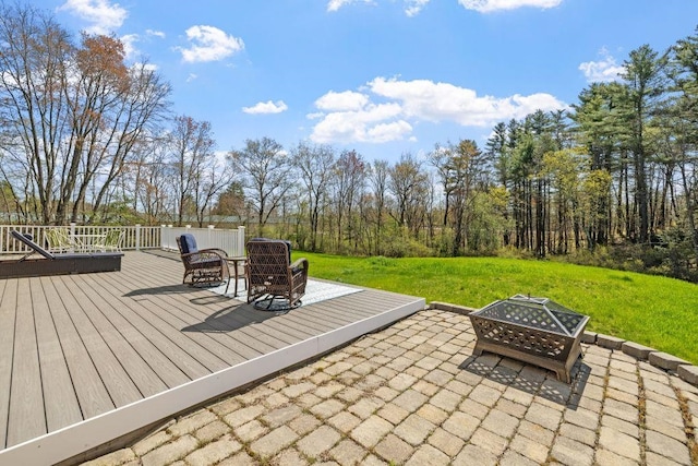 view of patio / terrace featuring a deck and an outdoor fire pit
