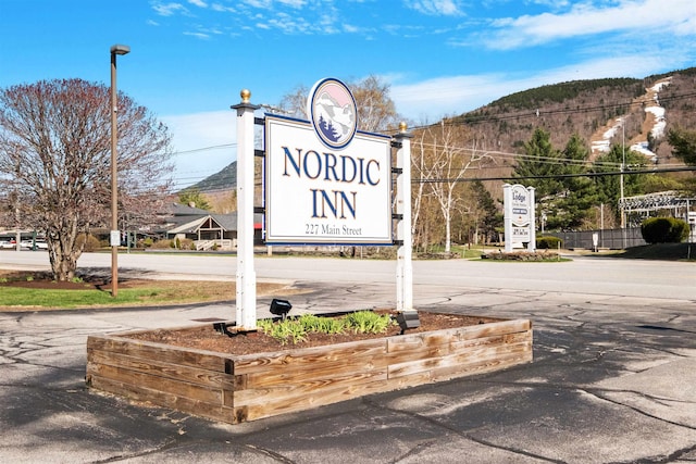 community sign with a mountain view