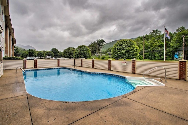 view of swimming pool with a fenced in pool, a patio area, and fence