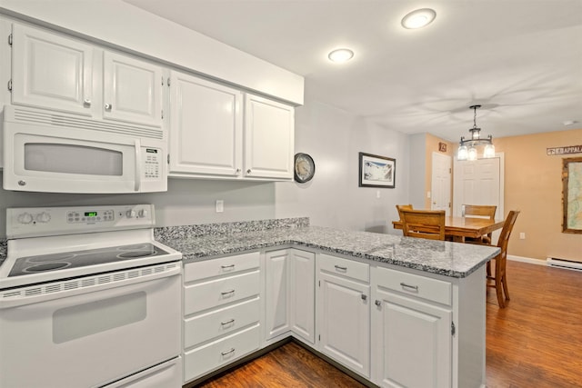 kitchen with a peninsula, white appliances, white cabinetry, and dark wood finished floors