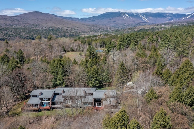 birds eye view of property featuring a view of trees and a mountain view