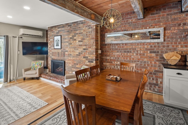 dining room featuring wood finished floors, brick wall, beamed ceiling, a wall unit AC, and wooden ceiling