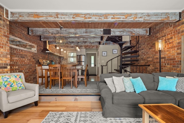 living room featuring wood ceiling, brick wall, beam ceiling, wood finished floors, and stairway