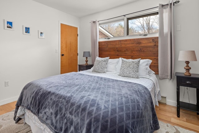 bedroom with baseboards and wood finished floors