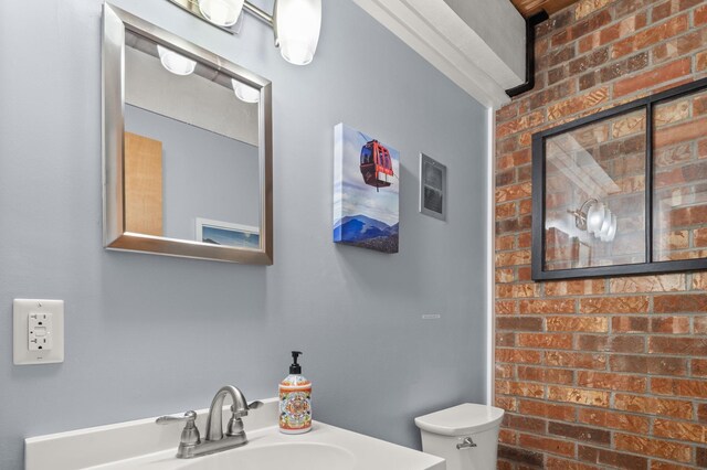 bathroom featuring toilet, visible vents, and a sink