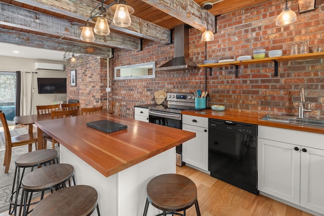 kitchen featuring wooden counters, black dishwasher, stainless steel electric range, wall chimney exhaust hood, and a wall mounted AC