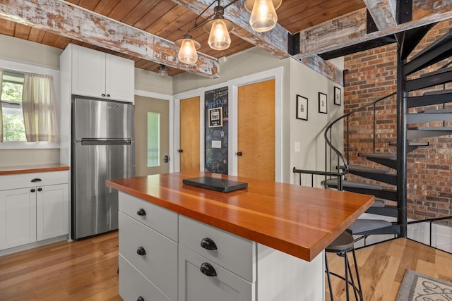 kitchen with freestanding refrigerator, wood counters, wooden ceiling, and light wood-style flooring