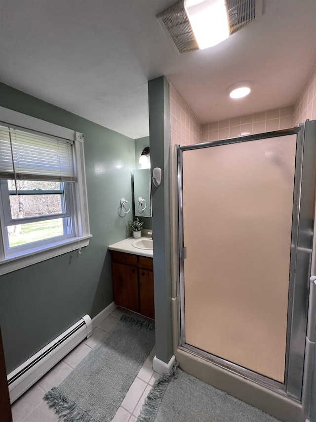 full bathroom with tile patterned flooring, vanity, a shower stall, a baseboard radiator, and visible vents