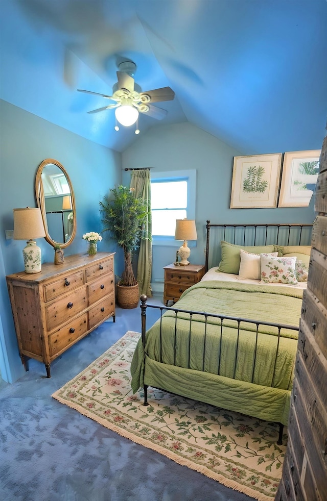 bedroom with a ceiling fan, carpet, and vaulted ceiling