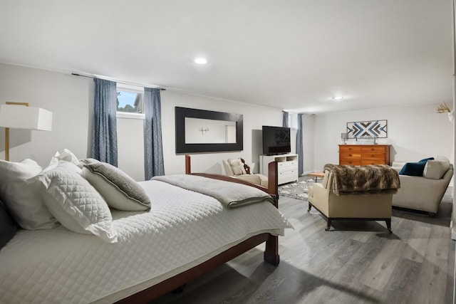 bedroom with recessed lighting and wood finished floors