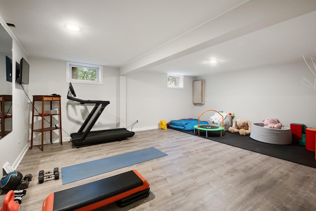 workout area featuring baseboards, recessed lighting, and wood finished floors