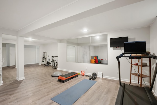 workout room with baseboards, recessed lighting, and wood finished floors