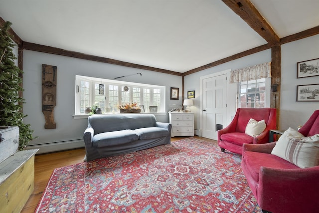living area with a baseboard heating unit and wood finished floors