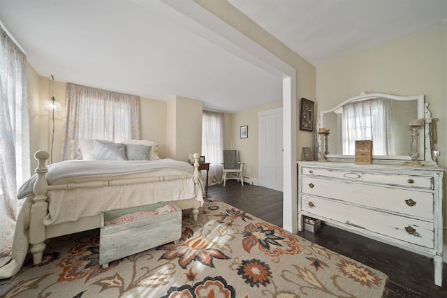 bedroom featuring vaulted ceiling and dark wood finished floors