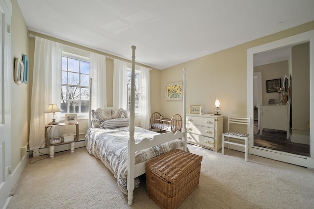 carpeted bedroom featuring a baseboard heating unit