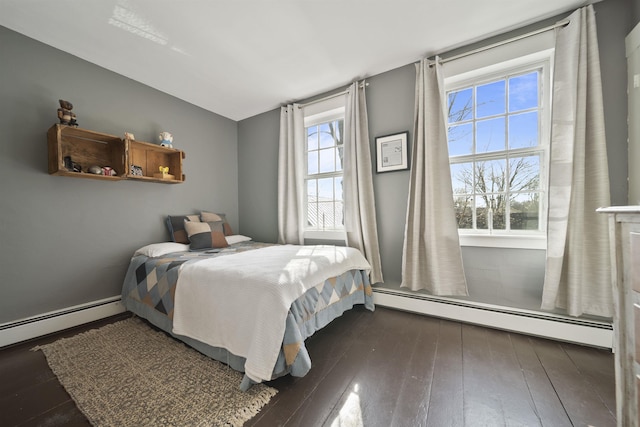 bedroom featuring wood-type flooring, baseboard heating, and lofted ceiling