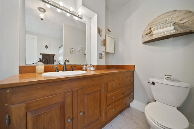 bathroom featuring vanity, marble finish floor, and toilet