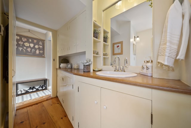 bathroom with vanity and hardwood / wood-style floors