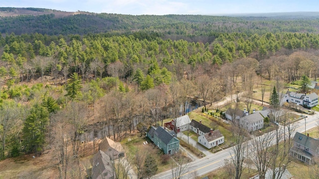birds eye view of property with a view of trees