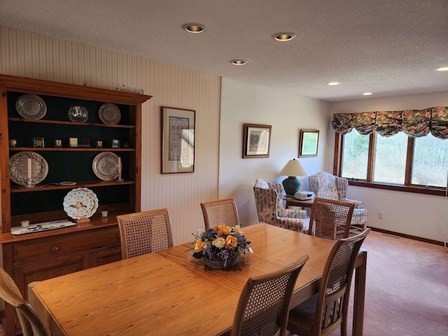 carpeted dining room with baseboards, recessed lighting, and a textured ceiling