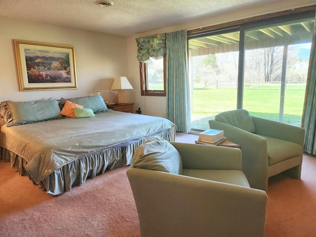 carpeted bedroom with access to outside and a textured ceiling