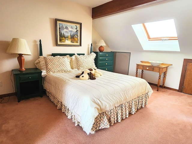 bedroom featuring vaulted ceiling with skylight, baseboards, and carpet flooring