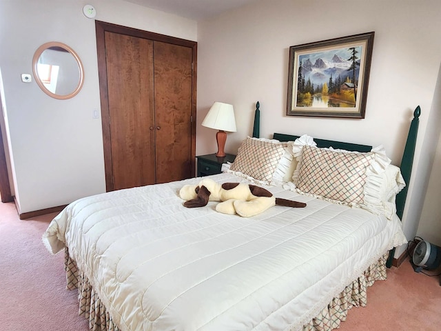 bedroom featuring a closet, carpet flooring, and baseboards