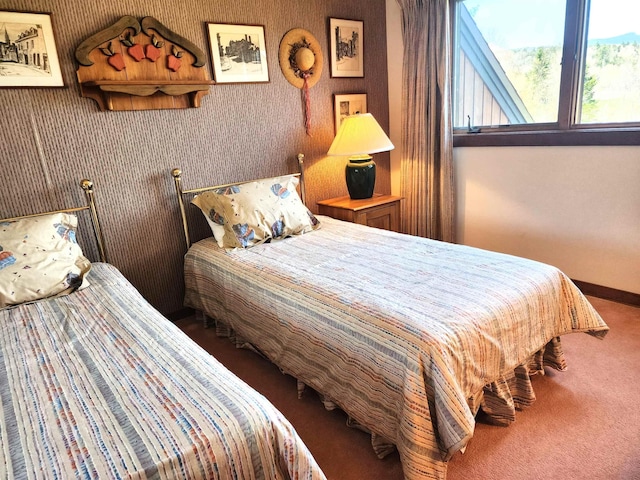 bedroom featuring baseboards and carpet