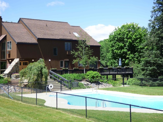 view of swimming pool with a fenced in pool, a lawn, fence, and stairway