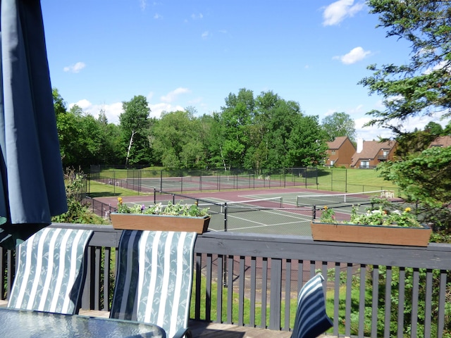 view of tennis court featuring fence