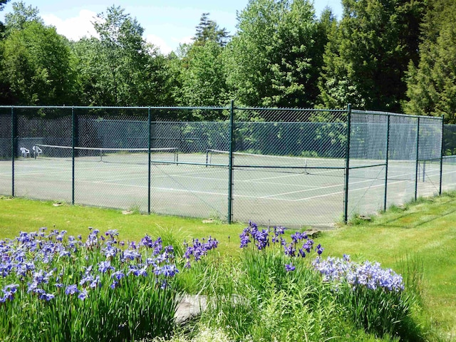 view of sport court with fence