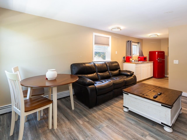 living room with baseboard heating and wood finished floors