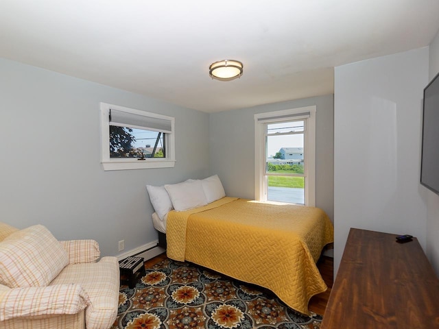 bedroom with baseboards and wood finished floors