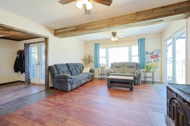 living area with beam ceiling, baseboards, hardwood / wood-style flooring, french doors, and a ceiling fan