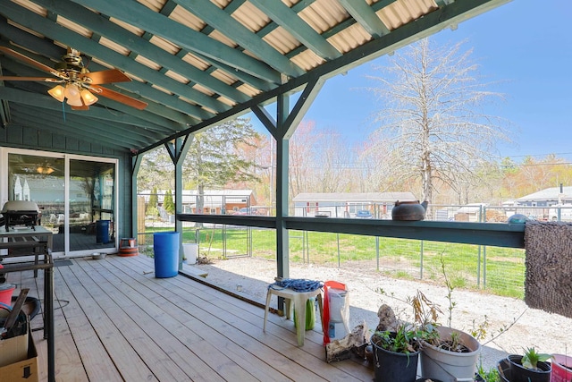 wooden deck with ceiling fan and fence