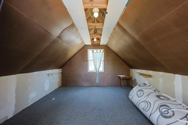 additional living space featuring vaulted ceiling and carpet