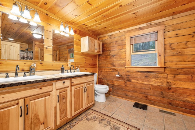 bathroom featuring tile patterned flooring, a sink, visible vents, and toilet