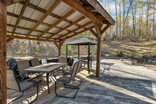 wooden terrace with a gazebo and outdoor dining area