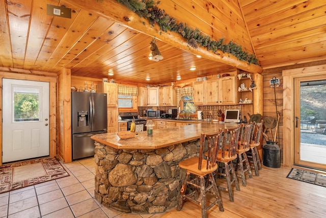 kitchen featuring wooden ceiling, appliances with stainless steel finishes, and plenty of natural light