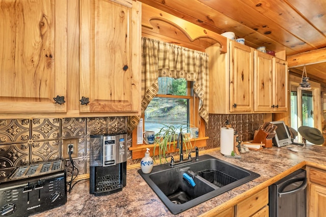 kitchen featuring stainless steel dishwasher, decorative backsplash, a sink, and light brown cabinets