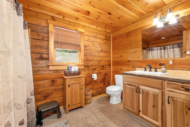 full bath featuring tile patterned flooring, vanity, toilet, wood walls, and wood ceiling