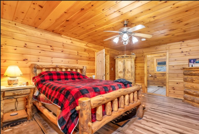 bedroom with wooden walls, wooden ceiling, and wood finished floors