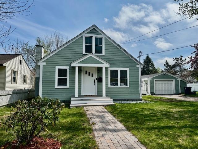 20 Underhill St, Nashua, NH 03060 - bungalow-style house featuring fence, a garage, a front yard, a chimney, and an outdoor structure